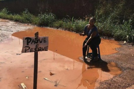 Moradora coloca placa de 'pague e pesque' em buraco de rua alagada e ironiza prefeitura de Boa Vista: 'obrigada'